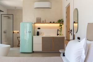 a kitchen with a refrigerator in a room at Ivy's Natural Resort in Arnados