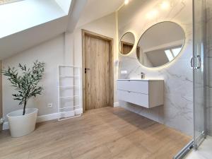 a bathroom with a sink and a mirror at Holiday House by Baltic Home in Świnoujście +22 photos