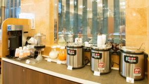a counter with three coffee machines on top of it at Toyoko Inn Hokkaido Kitami Ekimae in Kitami