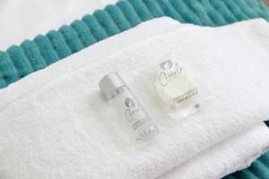 two bottles of soap sitting on top of a towel at Magic Trastevere suite on roof terrace in Rome