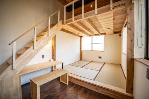 Postel nebo postele na pokoji v ubytování 佐渡ゲストハウス サドヨイ