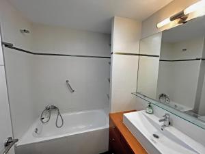 a bathroom with a tub and a sink and a mirror at Apartament Marina Roses 3 in Roses +16 photos