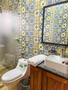 a bathroom with a toilet and a sink and a mirror at 2 bedroom apartment Kigo in Kigo +17 photos