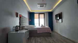 a bedroom with a bed and a television in a room at Pasa Tatil Koyu in Akcaabat +16 photos