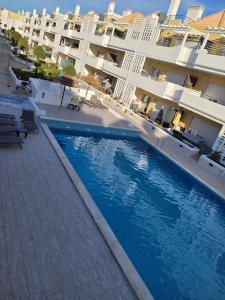 a swimming pool in front of a building at A Cabaninha - T2 Cabanas Beach in Tavira