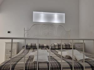 a bedroom with a bed with a metal headboard at Dimora di Ponente in Ostuni