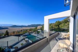 a view from the balcony of a house with a swimming pool at Luxury Villa San Rocco in Desne