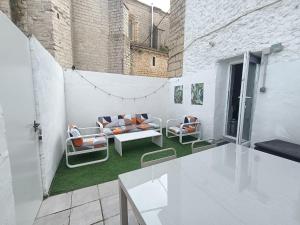 a living room with a couch and chairs on a balcony at Casa Nentis in Mucientes