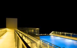 a large swimming pool at night on a building at SeaVista Studios in Negombo