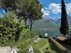 a garden with a view of a lake and mountains at Residence Matilde in Oliveto Lario