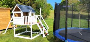 a play set with a house and a trampoline at Fewo Traum in Neppermin