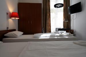 Postel nebo postele na pokoji v ubytování Hotel Xantener Eck