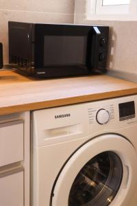 a microwave sitting on top of a washing machine at Incredible sea views in Benidorm