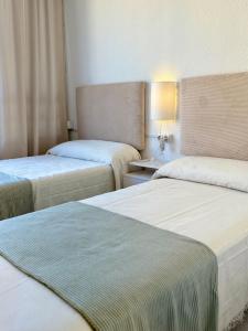a room with two beds and a table with a lamp at Incredible sea views in Benidorm +35 photos