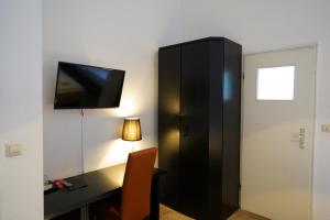 TV a/nebo společenská místnost v ubytování Hotel Xantener Eck