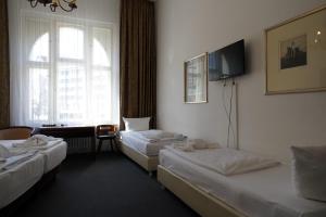 Postel nebo postele na pokoji v ubytování Hotel Xantener Eck