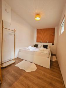 a bedroom with a large white bed in a room at Ljubljana Center Budget Apartment in Ljubljana