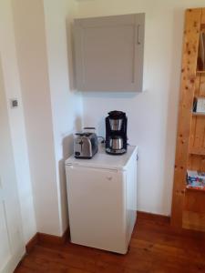 a toaster sitting on top of a white refrigerator at Fewo Arnsdorf in Arnsdorf +6 photos