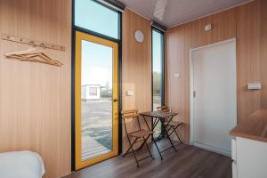 a room with a table and a door with a window at Lantian Cottage X by Tiny Away in Chen-shan-ts'un