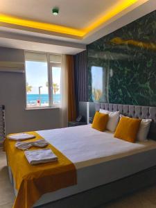 A bed or beds in a room at ERDEM HOTEL