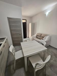 a kitchen and living room with a table and chairs at Holiday home Gala in Torre Squillace