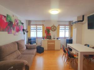 a living room with a couch and a table at The family bienvenidos a Canfranc in Canfranc-Estación
