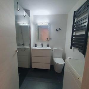 a white bathroom with a sink and a toilet at The family bienvenidos a Canfranc in Canfranc-Estación +36 photos