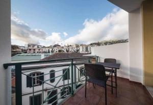 a balcony with two chairs and a table on a building at Alex Apartment by Mth in Funchal