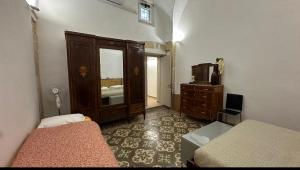 a bedroom with a bed and a dresser and a mirror at Casa Scarciglia in Minervino di Lecce