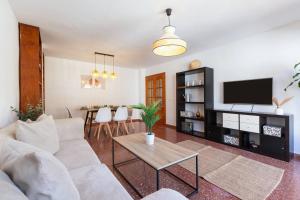 a living room with a white couch and a table at Casa Sánchez. Old Town Marbella in Marbella