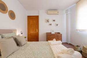 a bedroom with a bed with towels on it at Casa Sánchez. Old Town Marbella in Marbella