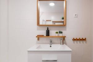 a bathroom with a white sink and a mirror at Casa Sánchez. Old Town Marbella in Marbella +31 photos