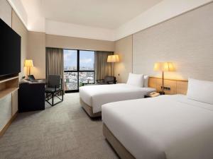 Grand Mercure Singapore Roxy客房内的一张或多张床位