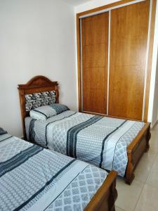a bedroom with two twin beds and a closet at Oued laou beach in Oued Laou