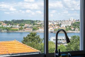 a view of a city from a kitchen window at Casa KAD in Vila Nova de Gaia