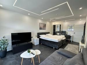 a living room with a bed and a couch at Cityferienwohnung in Emmerich