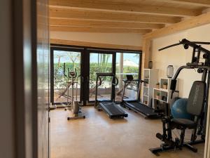 a gym with several tread machines in a room at La Bergamina Hotel & Restaurant in Arcore