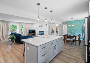a kitchen and living room with a white counter top at Spacious and Luxury Designed Ranch with Game Room in Strongsville +57 photos