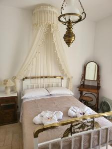 a bedroom with a white bed with towels on it at Alexia's resorts in Samos