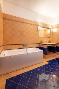 a bathroom with a large tub and a sink at Vista Mare Blu House in Agioi Theodoroi
