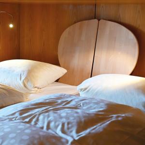 a close up of a bed with pillows on it at Pension Sonne Hartha in Hartha