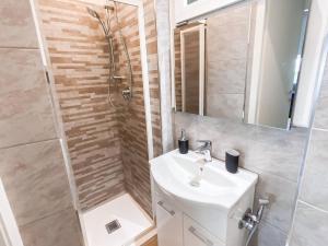 a bathroom with a sink and a shower at Piazza Vittorio Central Suite in Turin