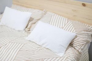 a bed with two pillows on top of it at Martinez de la Riva I in Madrid