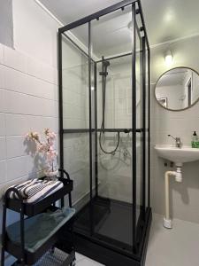 a glass shower in a bathroom with a sink at West coast villa with stunning ocean view ! in Hovenäset +38 photos
