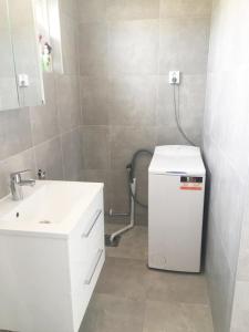 a white bathroom with a sink and a mirror at West coast villa with stunning ocean view ! in Hovenäset +31 photos