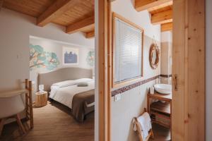 a bedroom with a bed and a bathroom with a window at La Casa Di Pinocchio in Enna