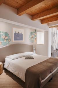 a bedroom with a large bed with wooden ceilings at La Casa Di Pinocchio in Enna +55 photos