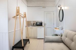 a living room with a couch and a kitchen at Neachora Beachfront Suites in Chania