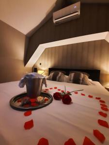 a bed with red hearts on it with a plate on it at Clos des Thermes-Zanzibar in Liège +21 photos
