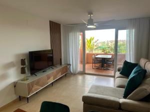 a living room with a couch and a flat screen tv at Casa Serenidad in Torre-Pacheco